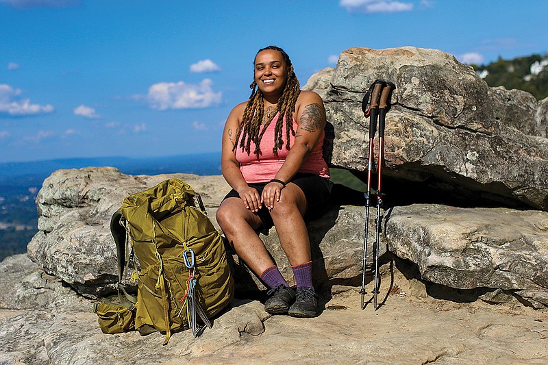 Staff photo by Olivia Ross / Kanisa Hutchins, a local adventurer who hiked the entire Appalachian Trail in seven months, sits on Lookout Mountains Sunset Rock.