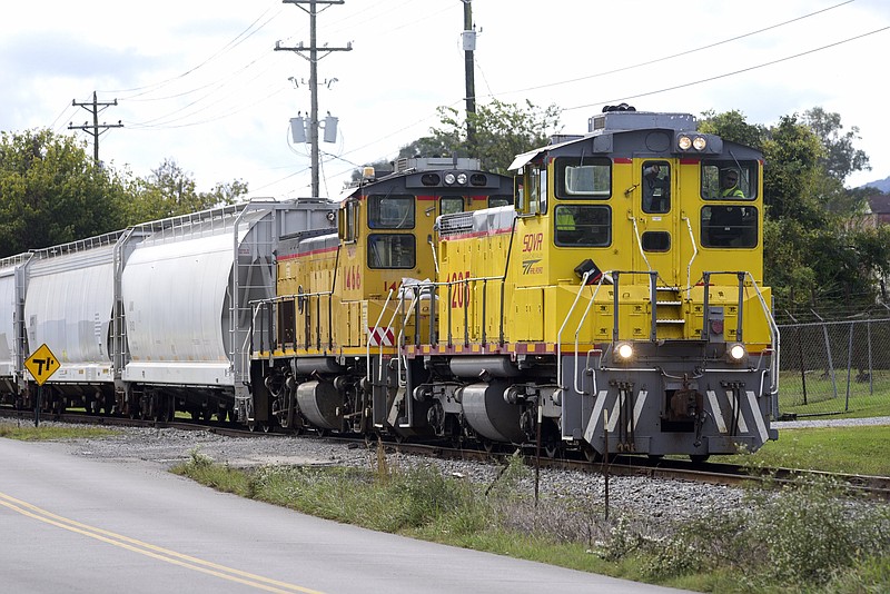 Staff Photo by Robin Rudd / The Sequatchie Valley Railroad pulls freight north along Railroad Avenue in South Pittsburg in 2021. The Sequatchie Valley Switching Co.'s rail is an 11.5-mile short-line railroad serving South Central Tennessee from a connection with CSXT at Bridgeport, Ala.