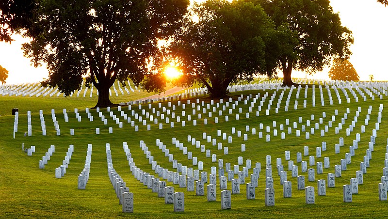 Staff Photo by Robin Rudd / Rays of sunlight illuminate graves at the Chattanooga National Cemetery on June 15, 2022. The cemetery is nearing capacity so the Department of Veterans Affairs announced Tuesday it is buying 270 acres in Meigs County to expand the Chattanooga National Cemetery.