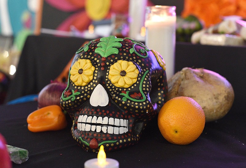 Staff File Photo by Matt Hamilton / A decorated skull sits on the ofrenda, a type of altar decorated with photos and mementos of dead loved ones, at the 2021 Day of the Dead celebration at the Creative Arts Guild in Dalton, Ga. This year's Dia de los Muertos will be celebrated there on Oct. 27.