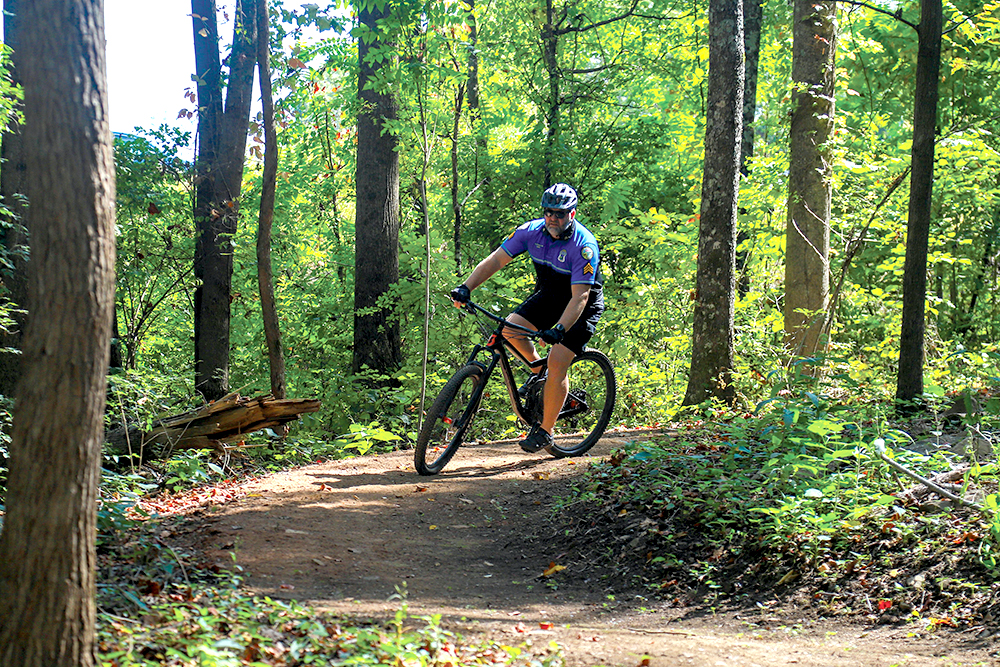 Staff photo by Olivia Ross / A cyclist tries out the new Aetna Trail.