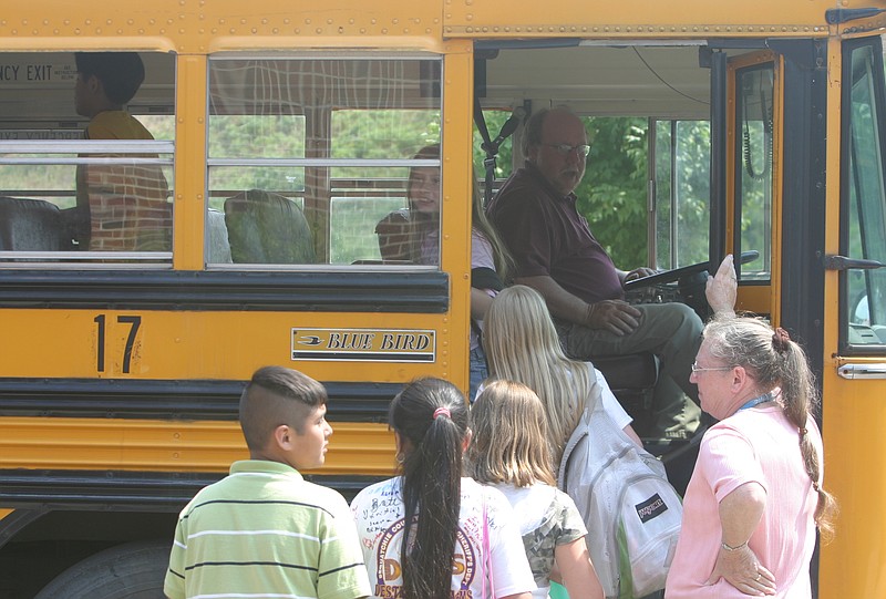 Staff Photo / Sequatchie County Schools are dismissing early Friday over a shortage of substitute bus drivers in Dunlap, Tenn. Here, students at Sequatchie County's Griffith Elementary School board a school bus in 2007 during another bus driver shortage.