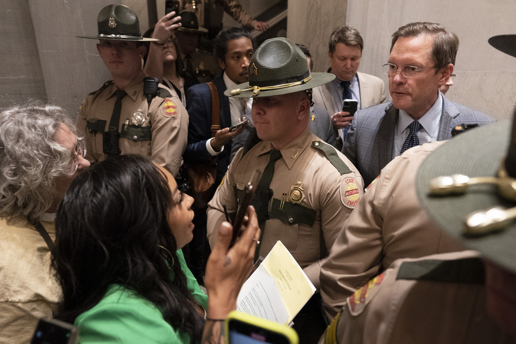 Speaker of the House Cameron Sexton, R-Crossville, right, listens to constituents from behind Tennessee State Troopers outside the House chambers as they demand gun reform laws April 17 in Nashville. (AP Photo/George Walker IV)