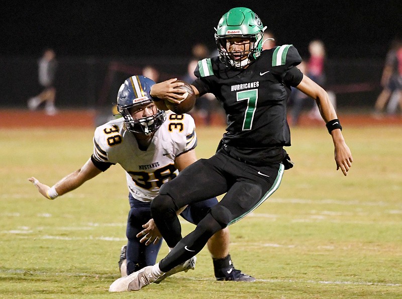 Staff photo by Robin Rudd / East Hamilton quarterback Trey Crawford (7) tries to avoid the tackle of Walker Valley's Conner Phillips during a TSSAA Region 4-5A game Friday night at East Hamilton.
