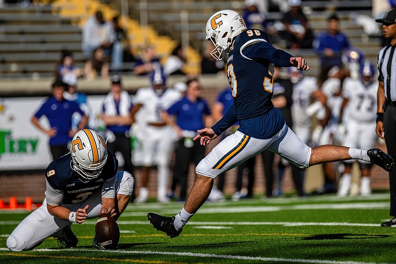 UTC Athletics photo by Ray Soldano / UTC quarterback Chase Artopoeus holds the football for Clayton Crile's kick during a SoCon game against Western Carolina on Oct. 7 at Finley Stadium. Crile, a graduate transfer, was an All-American punter for Division II Catawba College in 2021, but he has recently started handling all kicking duties for the Mocs.