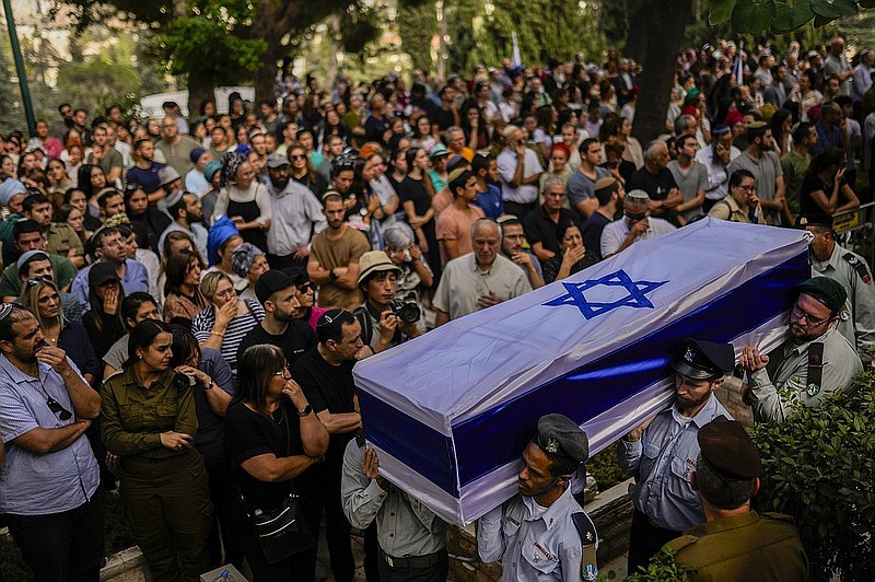 On Thursday, Israeli soldiers carry the flag-covered coffin of Shilo Rauchberger at the Mount Herzl cemetery in Jerusalem. (AP Photo/Francisco Seco)