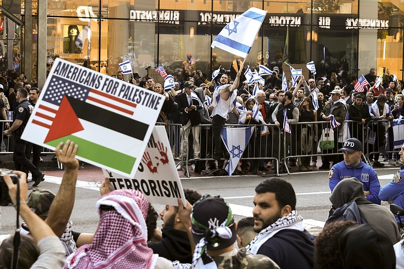 Photo/Jeenah Moon/The New York Times / Protesters in support of Israel and Palestine are stationed on opposite sides of the street during a rally in Manhattans Times Square on Friday, Oct. 13, 2023.