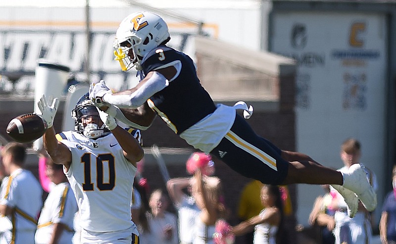 Staff photo by Matt Hamilton / UTC's Clay Fields III leaps to break up a pass intended for East Tennessee State's Tommy Winton III on Saturday at Finley Stadium.
