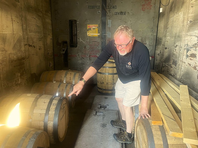 Photo by Anne Braly / Amid the barrels is Bill Lee, owner of Gate 11 Distillery in Chattanooga.