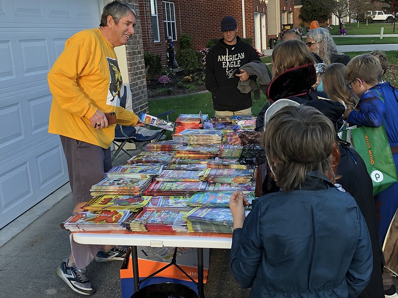 Contributed photo / Mike Dunne hands out comic books, storybooks and coloring books to trick-or-treaters in 2021. Dunne has made handing out reading material a yearly tradition at his Hixson residence.