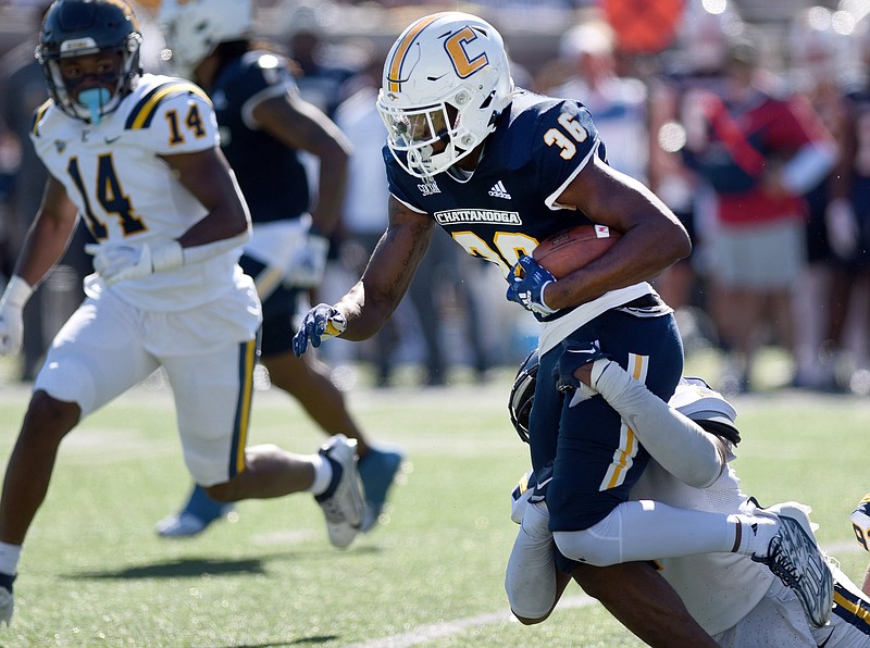 Staff photo by Matt Hamilton / UTC running back Reggie Davis (36) tries to break away from an East Tennessee State defender during last Saturday's SoCon game at Finley Stadium. With prolific rusher Ailym Ford's UTC career over due to injury, the Mocs will need Jackson and other backs to take on a heavier load the rest of the season.