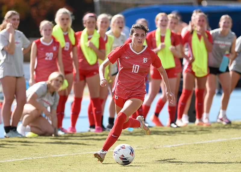 Staff photo by Matt Hamilton / With her Baylor teammates looking on from the sideline, Emily Betterton dribbles downfield during a TSSAA Division II-AA state semifinal against Hutchison on Thursday at GPS.