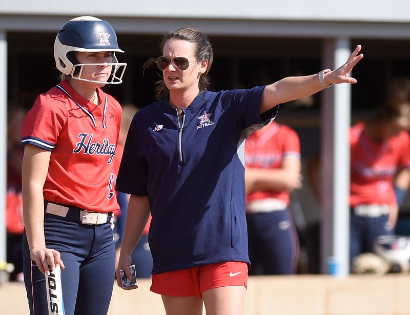 Staff photo by Matt Hamilton / Heritage softball coach Megan Crawford talks to Harper Carstens during a super regional playoff game at home on Oct. 19. Carstens hit a first-inning homer Thursday in a 10-0 win over Whitewater at the GHSA Class AAAA state tournament in Columbus.