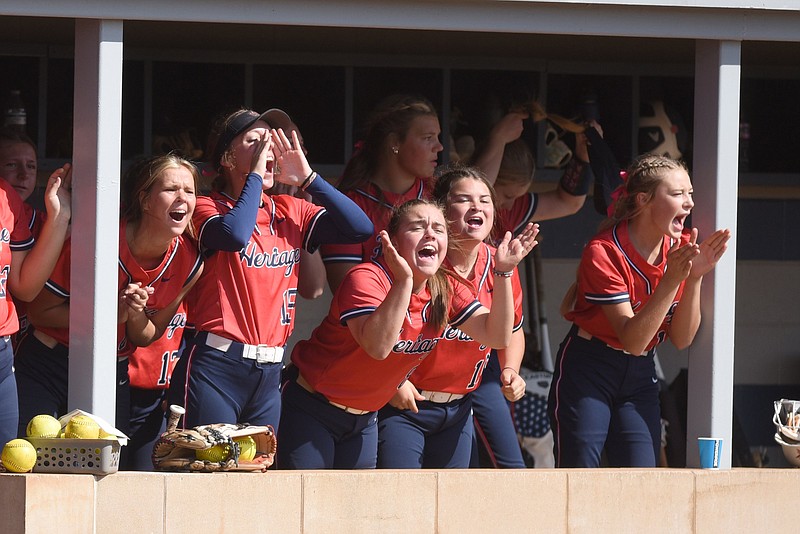 Staff photo by Matt Hamilton / Members of the Heritage softball team cheer from the dugout during a GHSA super regional playoff game at home on Oct. 19. The Generals completed an unbeaten postseason Saturday in Columbus, beating Wayne County in the Class AAAA title matchup for the program's fourth state championship.