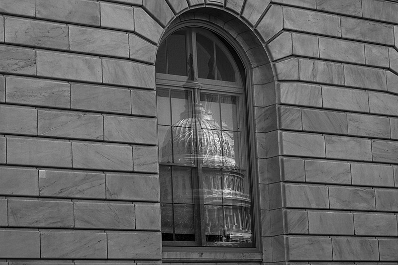 File photo/Kenny Holston/The New York Times / The U.S. Capitol building is reflected in a window in Washington on Sept. 13, 2023. “Starving the I.R.S. has long been a Republican priority; whats new is the partys willingness to serve that priority by endangering national security,” writes New York Times columnist Paul Krugman.