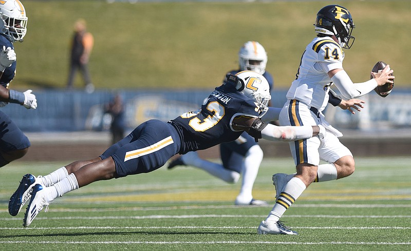 Staff photo by Matt Hamilton / UTC's Ben Brewton chases down East Tennessee State quarterback William Riddle at the line of scrimmage during a SoCon game on Oct. 21 at Finley Stadium.