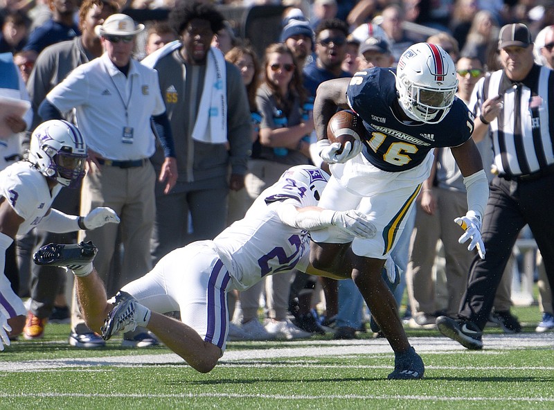 Staff photo by Matt Hamilton / UTC's Demetrius Coleman fights for yards as he carries the ball while Furman's Cally Chizik tries to bring him down during Saturday's game at Finley Stadium.