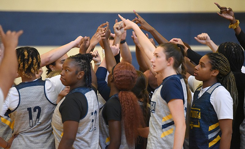 Staff photo by Matt Hamilton / UTC basketball players huddle up at the start of practice on Oct. 24. Coach Sean Poppie's Mocs, the reigning SoCon champions, tip off their 2023-24 season at 11 a.m. Monday against King University at McKenzie Arena.