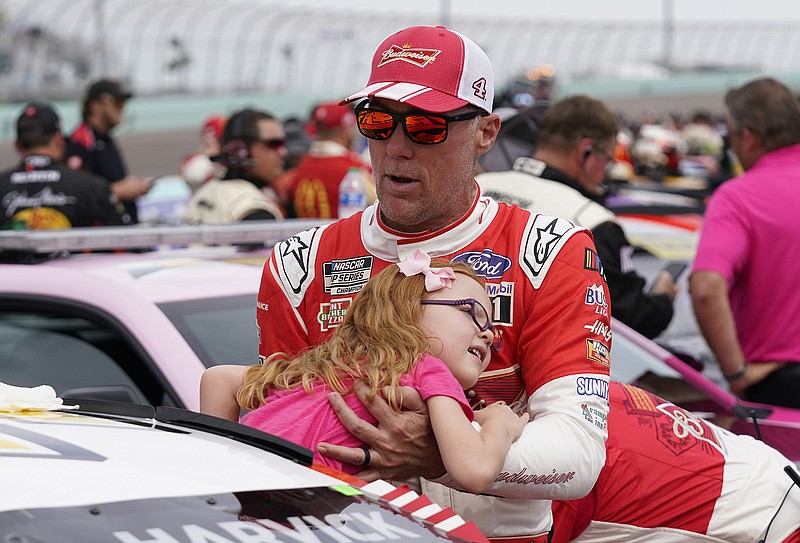 AP photo by Wilfredo Lee / Stewart-Haas Racing driver Kevin Harvick lifts his daughter Piper from his car before a NASCAR Cup Series race at Homestead-Miami Speedway on Oct. 22.