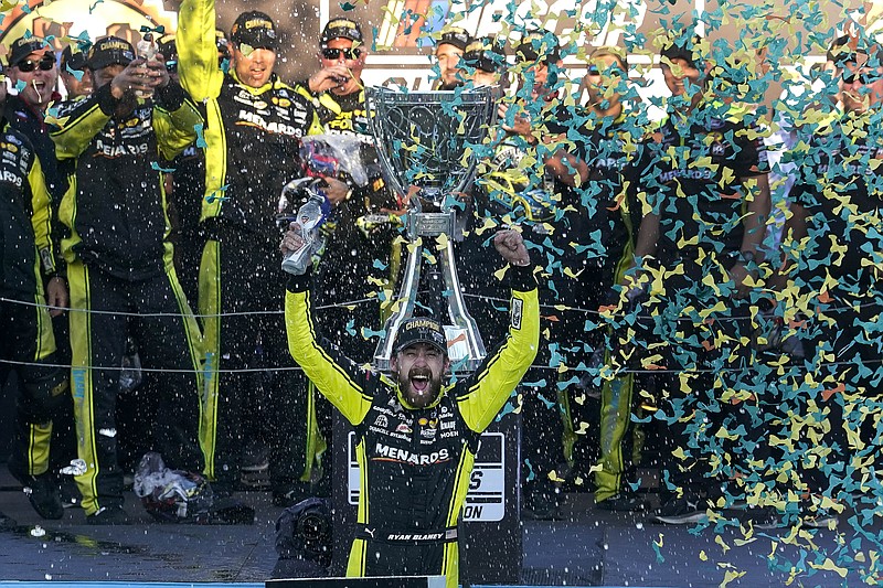 Ryan Blaney, foreground, celebrates after winning the NASCAR Cup Series Championship Cup at Phoenix Raceway, Sunday, Nov. 5, 2023, in Avondale, Ariz. (AP Photo/Darryl Webb)