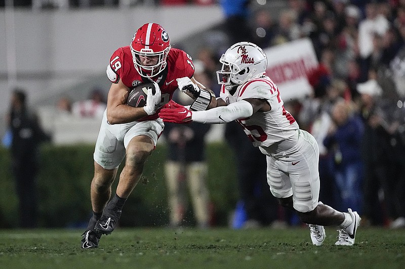 AP photo by John Bazemore / Georgia tight end Brock Bowers runs with the ball after a catch as Ole Miss safety Nick Cull defends during Saturday night's game in Athens, Ga.