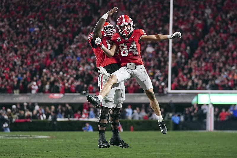 AP photo by John Bazemore / Georgia receiver Ladd McConkey (84) celebrates with offensive lineman Sedrick Van Pran after catching a touchdown pass during the Bulldogs' home win against Ole Miss on Saturday night.