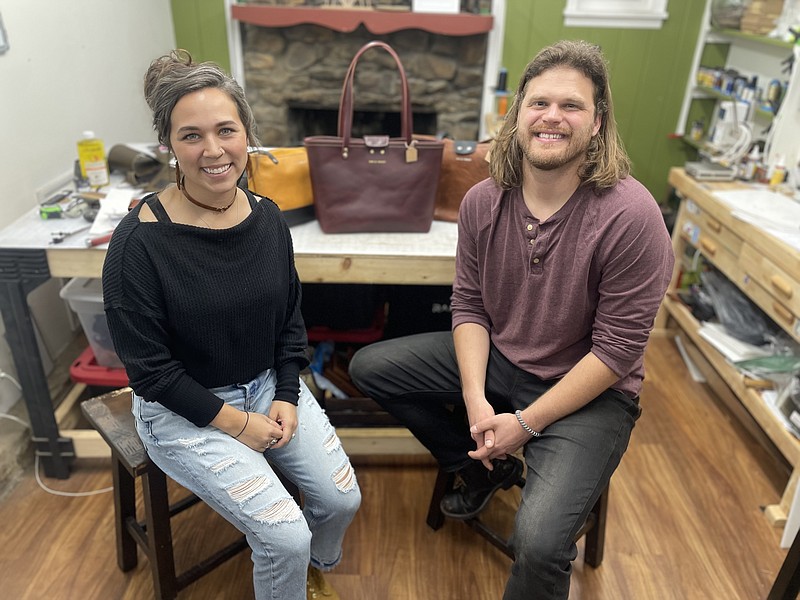 Staff photo by Mark Kennedy / Melina Holmes, left, and Chris Holmes are pictured in their home workshop in East Ridge this month. The couple make leather goods for their company Fox & Forest Leather. Their bags and wallets can be seen online or at the Chattanooga Market or Holiday Market at the Chattanooga Convention Center.
