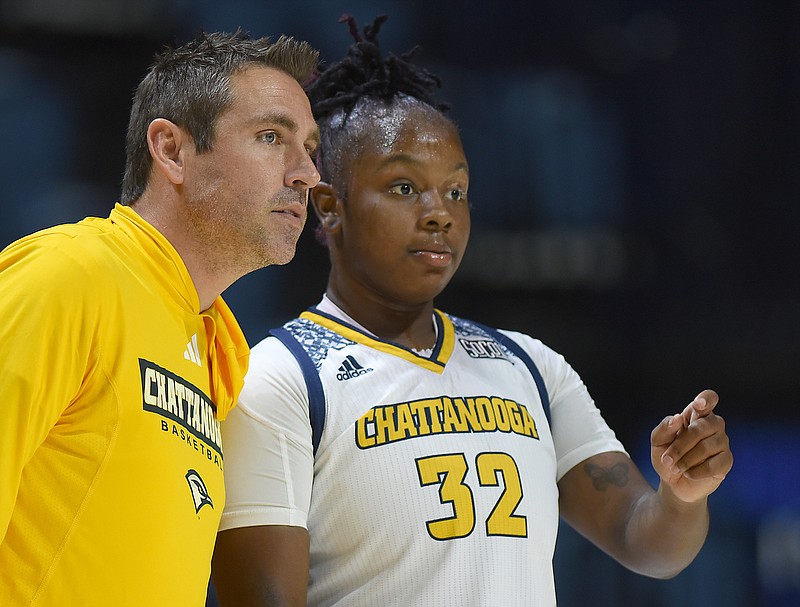 Staff photo by Matt Hamilton / UTC women's basketball coach Shawn Poppie talks with sophomore forward Raven Thompson during a timeout in Saturday's game against UVA Wise at McKenzie Arena.