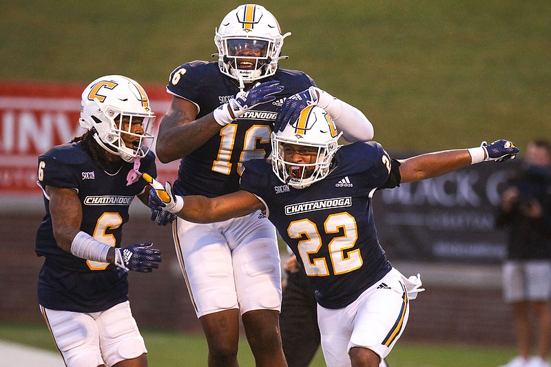 Staff photo by Olivia Ross / UTC receiver Javin Whatley, left, and tight end Camden Overton, center, celebrate with running back Lance Jackson after he scored a touchdown against The Citadel in a SoCon game on Sept. 16 at Finley Stadium.