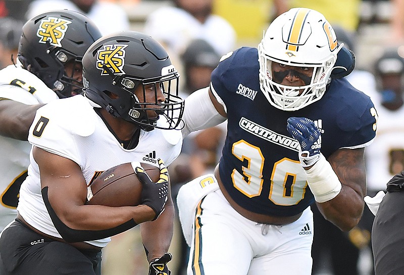 Staff photo by Matt Hamilton / UTC senior Jay Person (30) closes in on Kennesaw State's Michael Benefield during a Sept. 9 game at Finley Stadium. Person swept the SoCon defensive player of the year honors for the second straight season.
