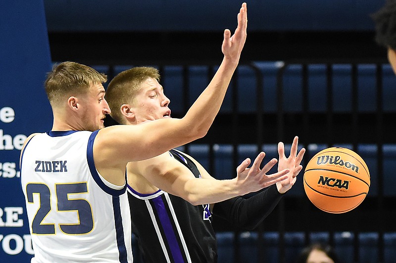 Staff photo by Matt Hamilton / Evansville's Ben Humrichous, right, loses the ball as UTC's Jan Zidek defends during the opening game of the Coke Zero Classic on Friday at McKenzie Arena.
