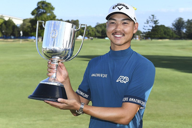 AAP Image photo via AP / Min Woo Lee holds his trophy after winning the Australian PGA Championship on Sunday in Brisbane.