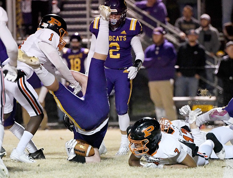 Staff photo by Robin Rudd / South Pittsburg's Logan Hargis upends the Oliver Springs ball carrier during a TSSAA Class 1A semifinal last Friday in Oliver Springs.