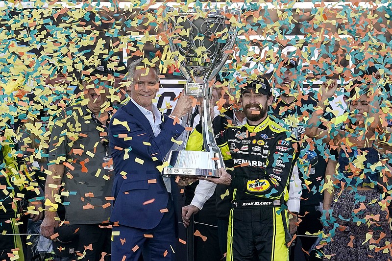AP photo by Darryl Webb / Ryan Blaney, right, receives the Cup Series Championship trophy from NASCAR president Steve Phelps on Nov. 5 at Phoenix Raceway.