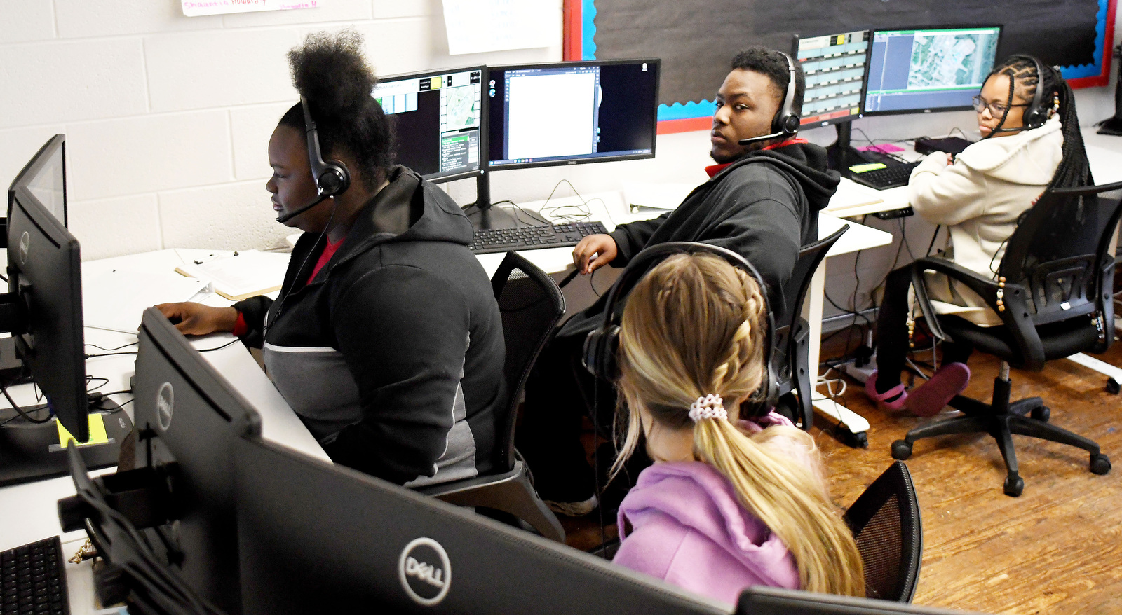 Staff Photo by Robin Rudd / From left, Dakota Outman, Hannah Merrell, LaVon Bledsoe and Mya Crafter discuss the simulation on Thursday. Brainerd High has launched a new 911 dispatch pathway this fall as part of the Future Ready Institute of Law, First Responders and Forensic Science.