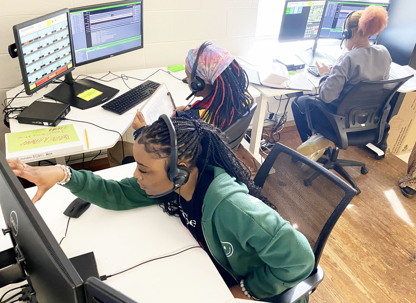 Staff Photo by Robin Rudd / From left, Jamariya Waddle, Shaunita Howard and Raquel Butts work on various situation simulations on Thursday. Brainerd High has launched a new 911 dispatch pathway this fall as part of the Future Ready Institute of Law, First Responders and Forensic Science.