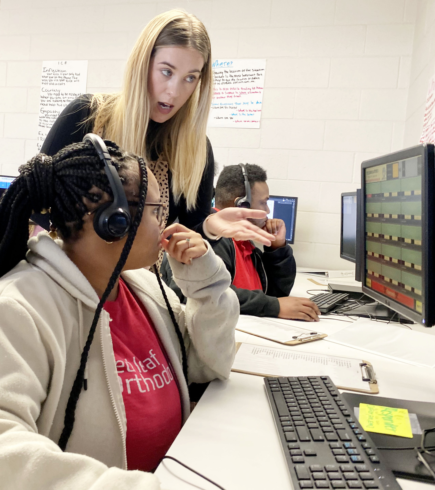 Staff Photo by Robin Rudd / Criminal justice teacher Alisha Chavez helps Mya Crafter during a simulation on Thursday. Brainerd High has launched a new 911 dispatch pathway this fall as part of the Future Ready Institute of Law, First Responders and Forensic Science.
