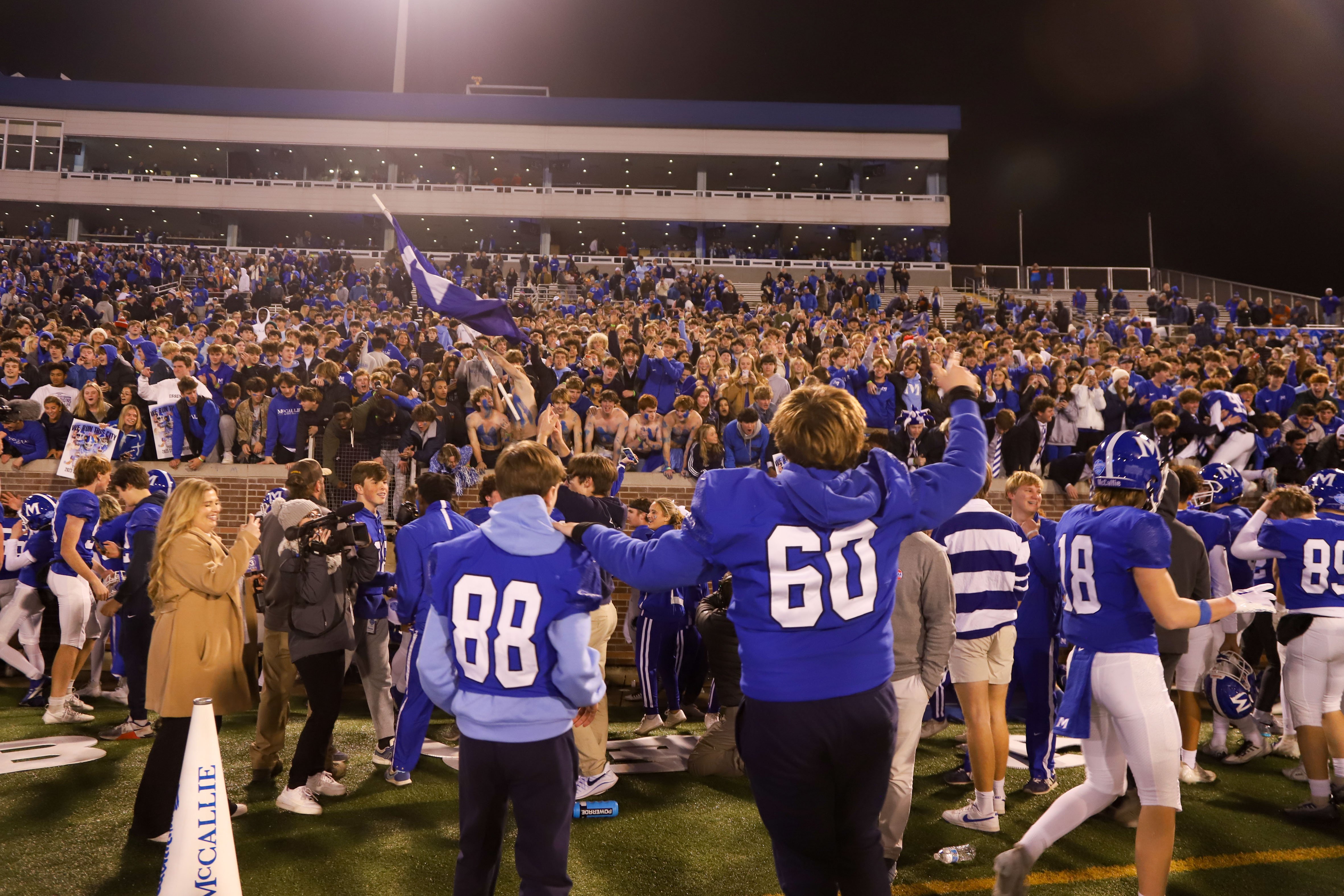 Staff photo by Olivia Ross / McCallie players rush to celebrate with the student section after their win against Baylor. Baylor took on McCallie on Thursday, November 30, 2023 in the BlueCross Bowl Division II-AAA state championship game at Finley Stadium.