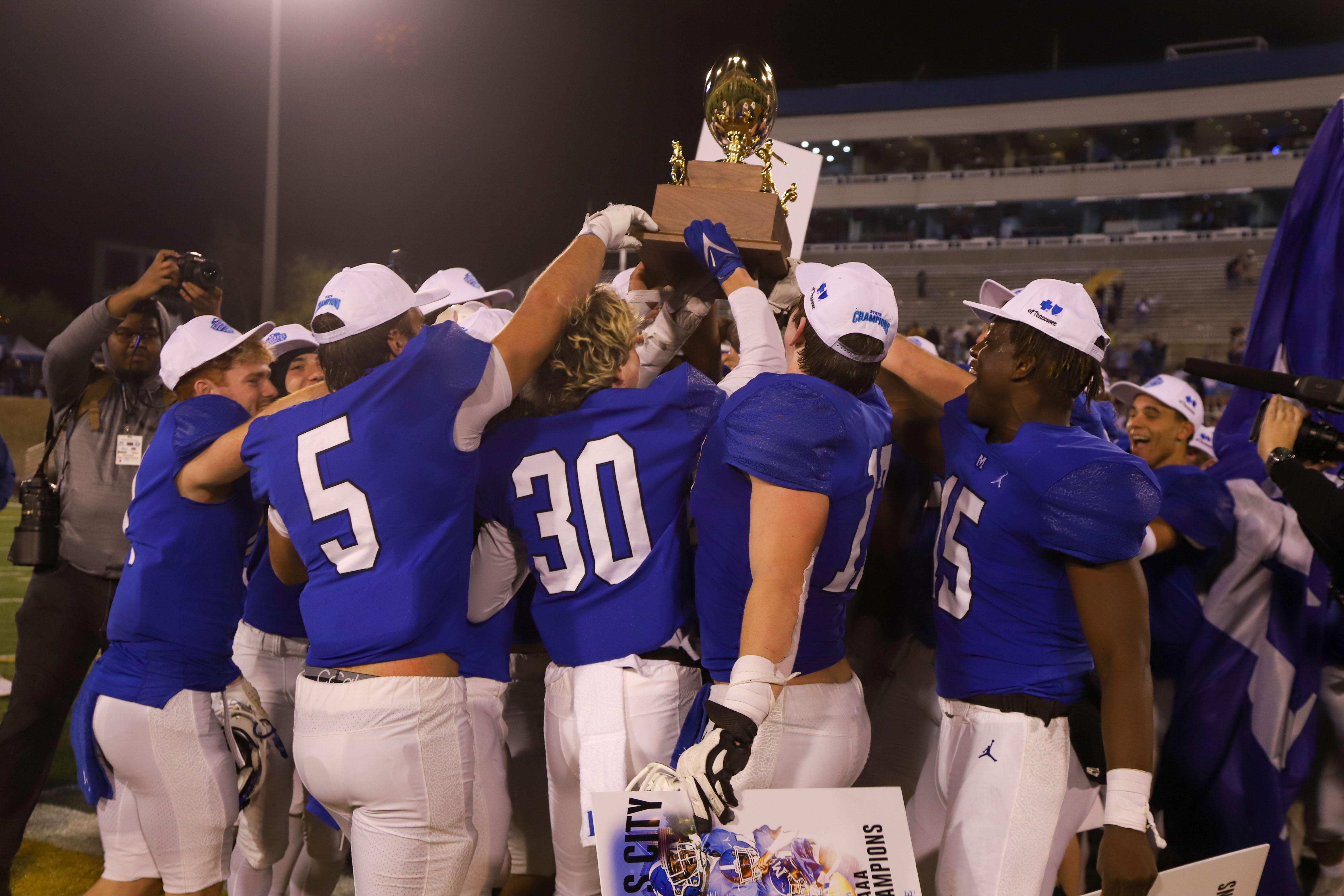 Staff photo by Olivia Ross / McCallie players hold up their trophy and celebrate. Baylor took on McCallie on Thursday, November 30, 2023 in the BlueCross Bowl Division II-AAA state championship game at Finley Stadium.