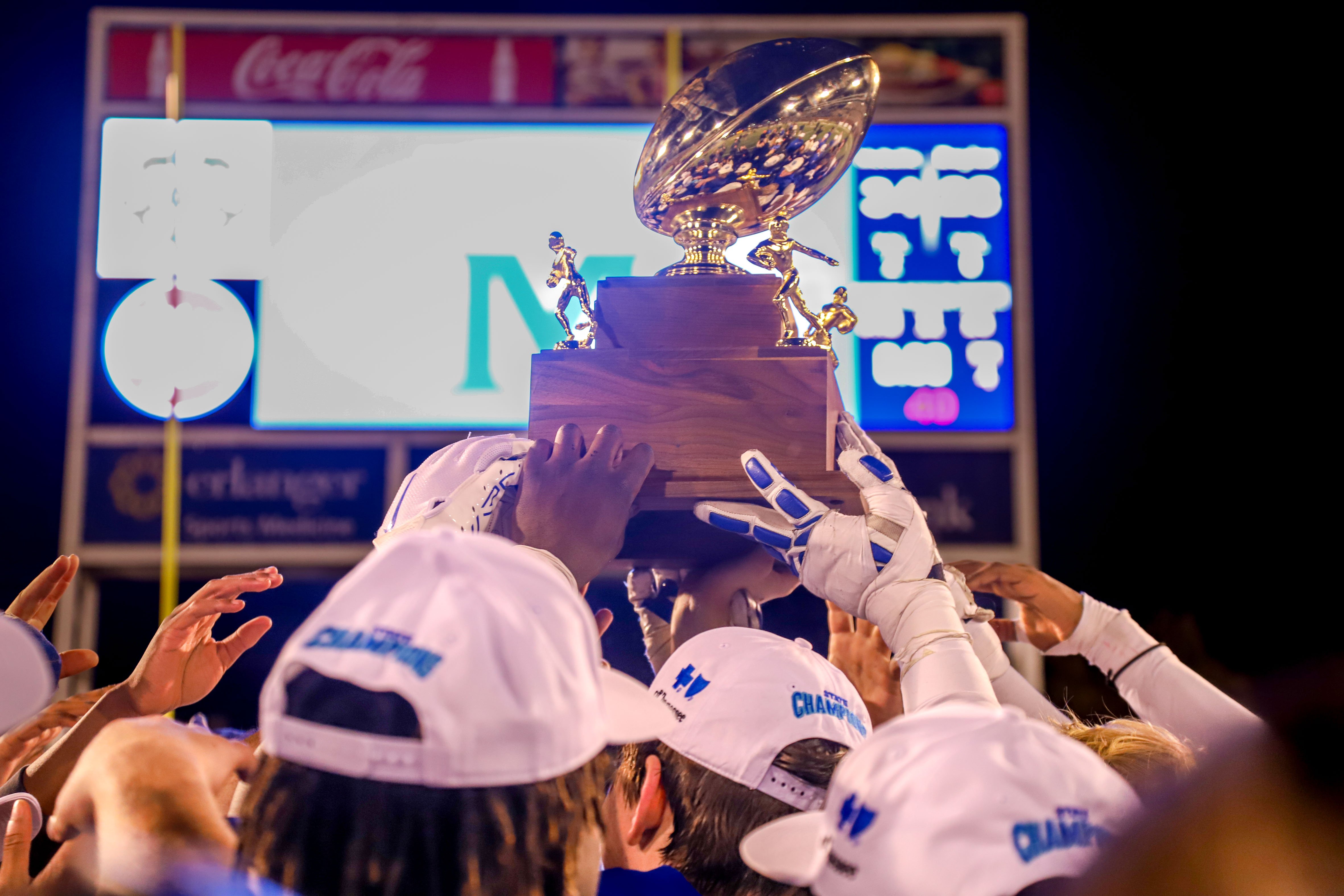 Staff photo by Olivia Ross / McCallie lifts their trophy high. Baylor took on McCallie on Thursday, November 30, 2023 in the BlueCross Bowl Division II-AAA state championship game at Finley Stadium.