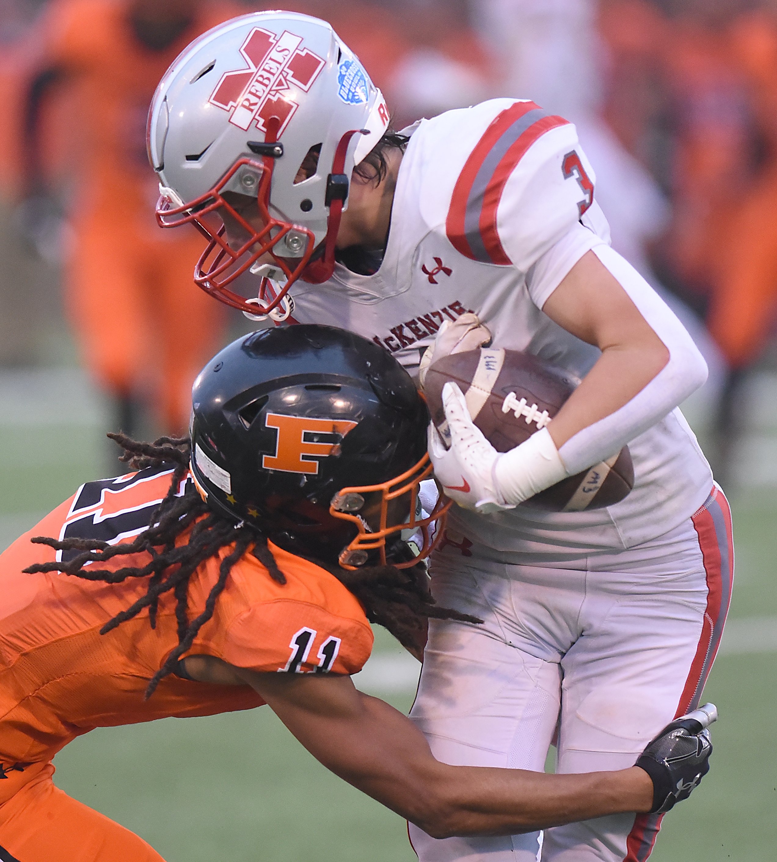 Staff photo by Matt Hamilton/ South Pittsburg's (11) Racash Kelly hits McKenzie (3) Lelan Gordon during the BlueCross Bowl Class 1A championship game at Finley Stadium on Friday, December 1, 2023.