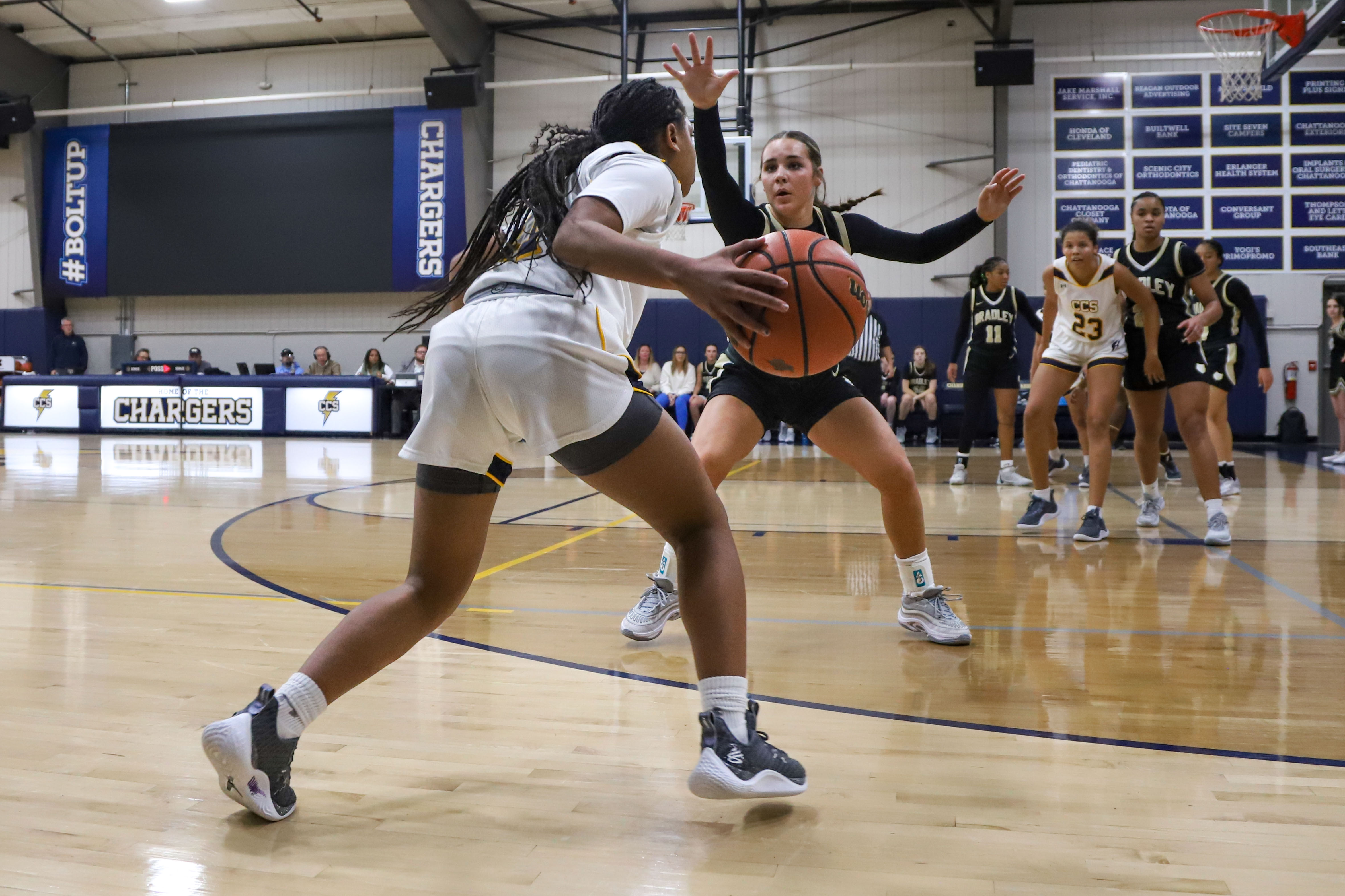 Staff photo by Olivia Ross / CCS's Momo Moore (11) looks to get around Bradleys Avery Brewer (2). Chattanooga Christian took on Bradley Central at home on Tuesday, December 5, 2023.