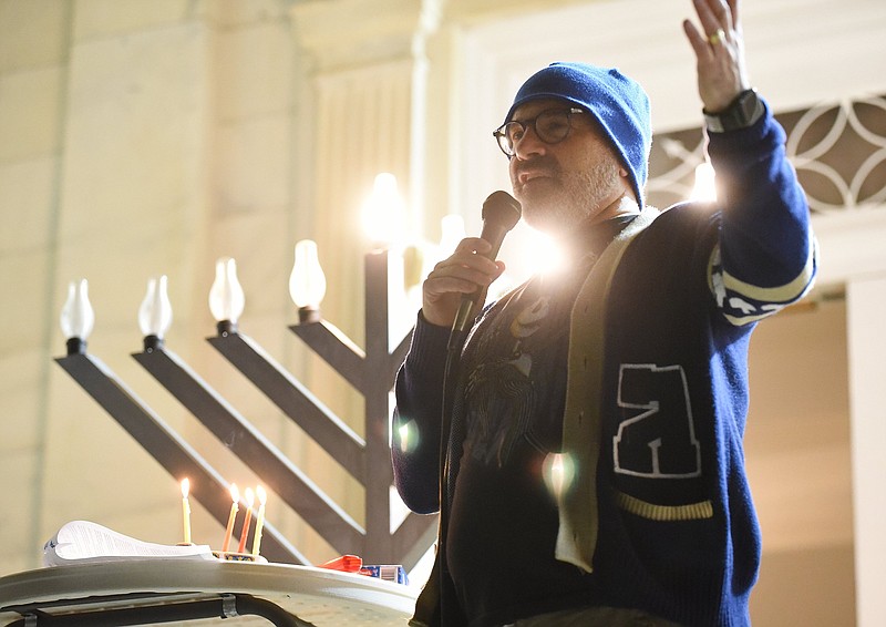 Staff photo by Matt Hamilton / Rabbi Craig Lewis speaks in front of a large electric menorah during a ceremony celebrating the third night of Hanukkah at the Mizpah Congregation in 2022.
