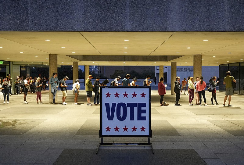 FILE - Voters wait in line at a polling place at the Lyndon B. Johnson School of Public Affairs in Austin, Texas, on election night Nov. 8, 2022. Midterm voters under 30 went 53% for Democrats compared to 41% for Republicans nationwide. That was down from such voters supporting President Joe Biden over his predecessor, Donald Trump, by a 61% to 36% in 2020, according to AP VoteCast, a sweeping national survey of voters in Novembers election. (Jay Janner/Austin American-Statesman via AP, File)