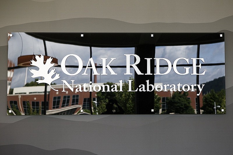 Staff photo / A sign for Oak Ridge National Laboratory is seen inside the conference center/visitor center/cafeteria building in 2019, in Oak Ridge, Tenn.