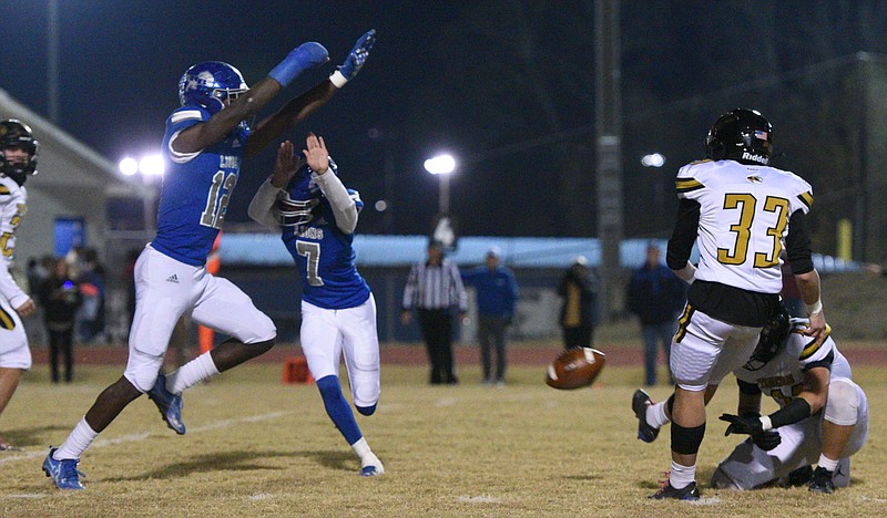 Staff photo by Matt Hamilton/ Red Bank's Kobe Smith (12) blocks a field goal attempt by DeKalb County during a first-round playoff game. Smith, who signed with Duke University on Wednesday, blocked four kicks last season.