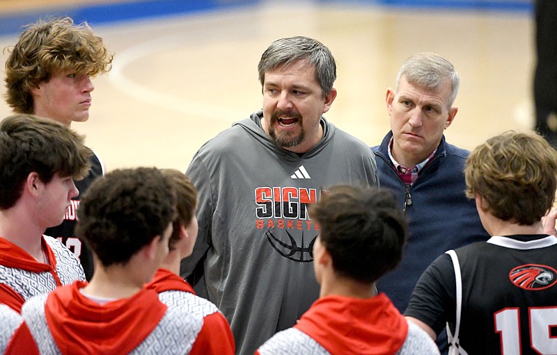 Staff photo by Robin Rudd / Signal Mountain boys' basketball coach Steve Redman, center, instructs the Eagles during a Times Free Press Best of Preps tournament game Friday at Chattanooga State.