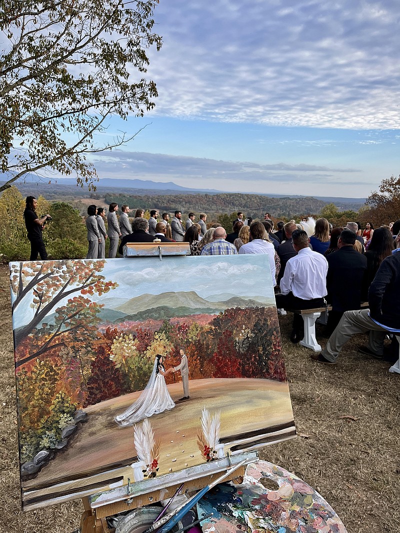 Heidi Fawn Wilson paints an image of the bride and groom during their wedding ceremony.