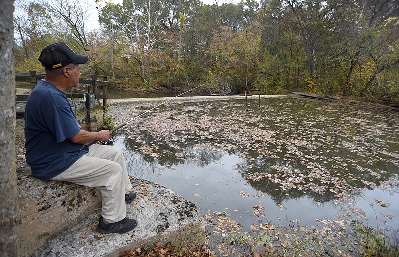 Staff photo by Matt Hamilton / Harry Smith fishes in the still waters of Coahulla Creek at Prater's Mill in Varnell on Oct. 30 after a month of dry weather left the creek at low levels.