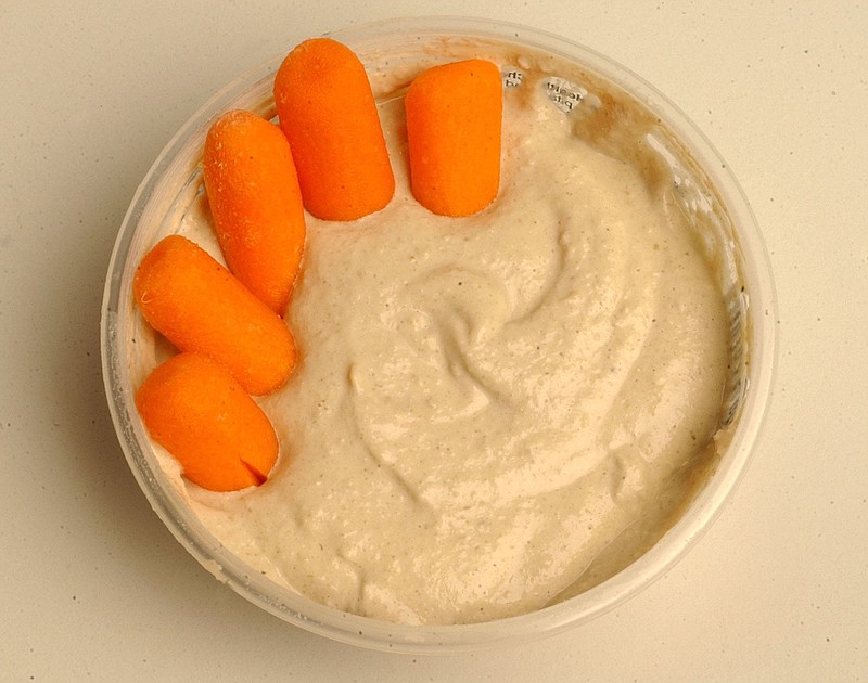 To add more fiber to your diet, try dipping carrots in hummus. / Tue Nam Ton/Contra Costa Times/MCT/File